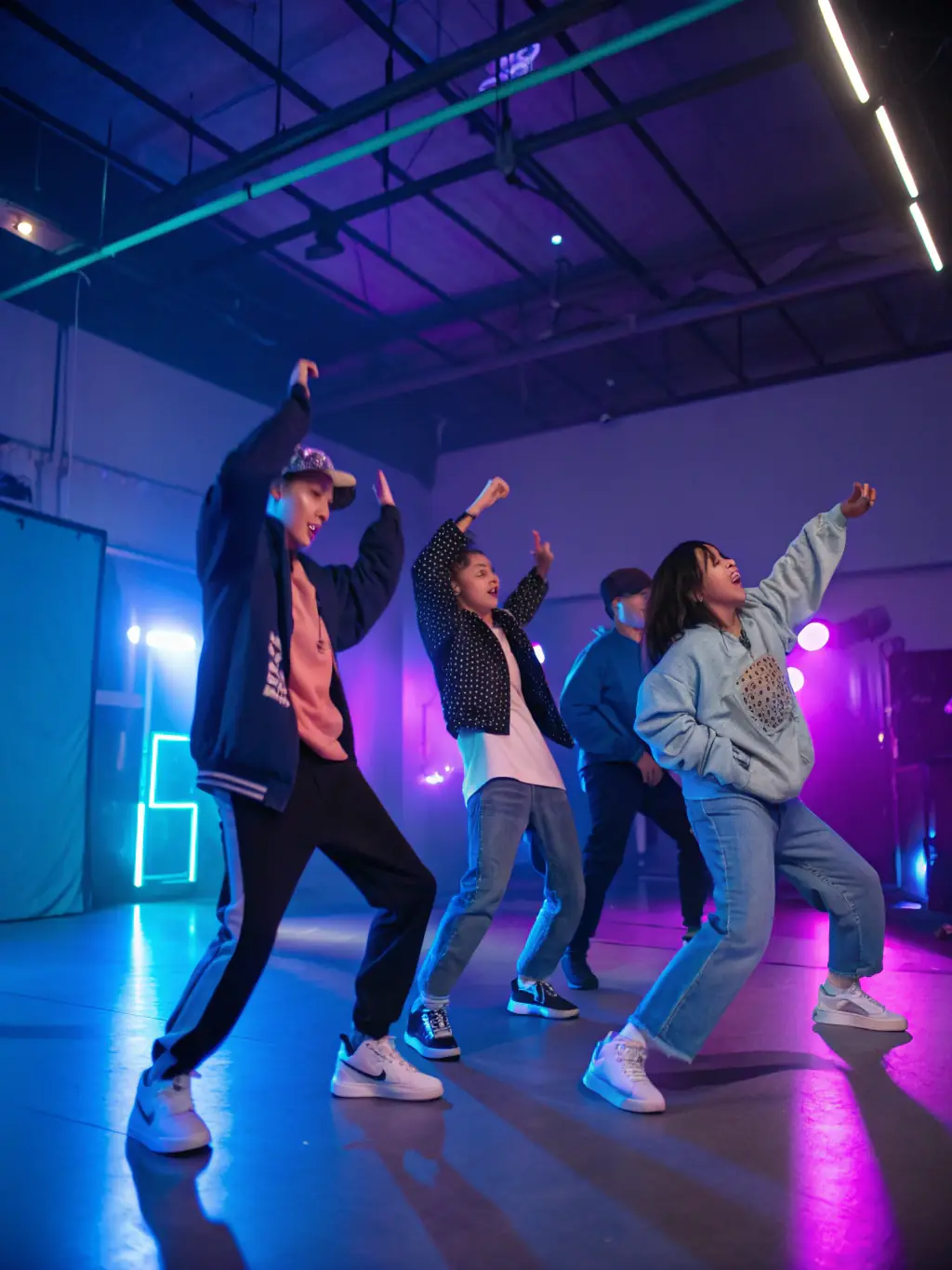 A dynamic photo of young adults engaged in a hip-hop dance class at the MJC, emphasizing energy and movement.